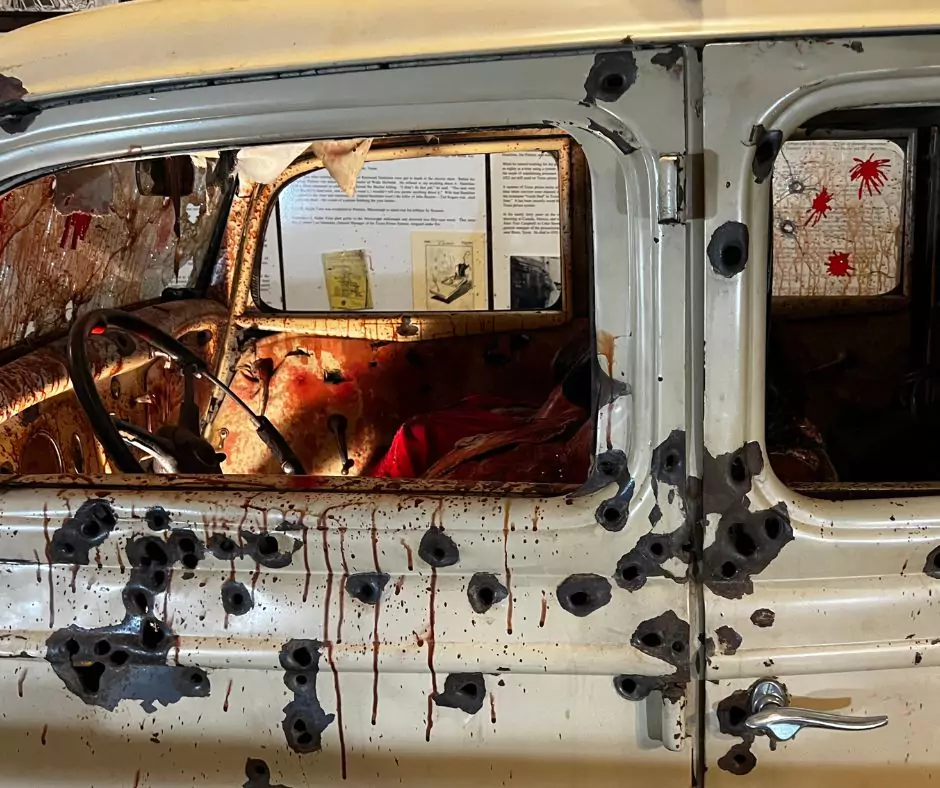 Close-up of Bonnie and Clyde’s Ford V8 riddled with bullet holes and blood-stained interior from the fatal ambush.