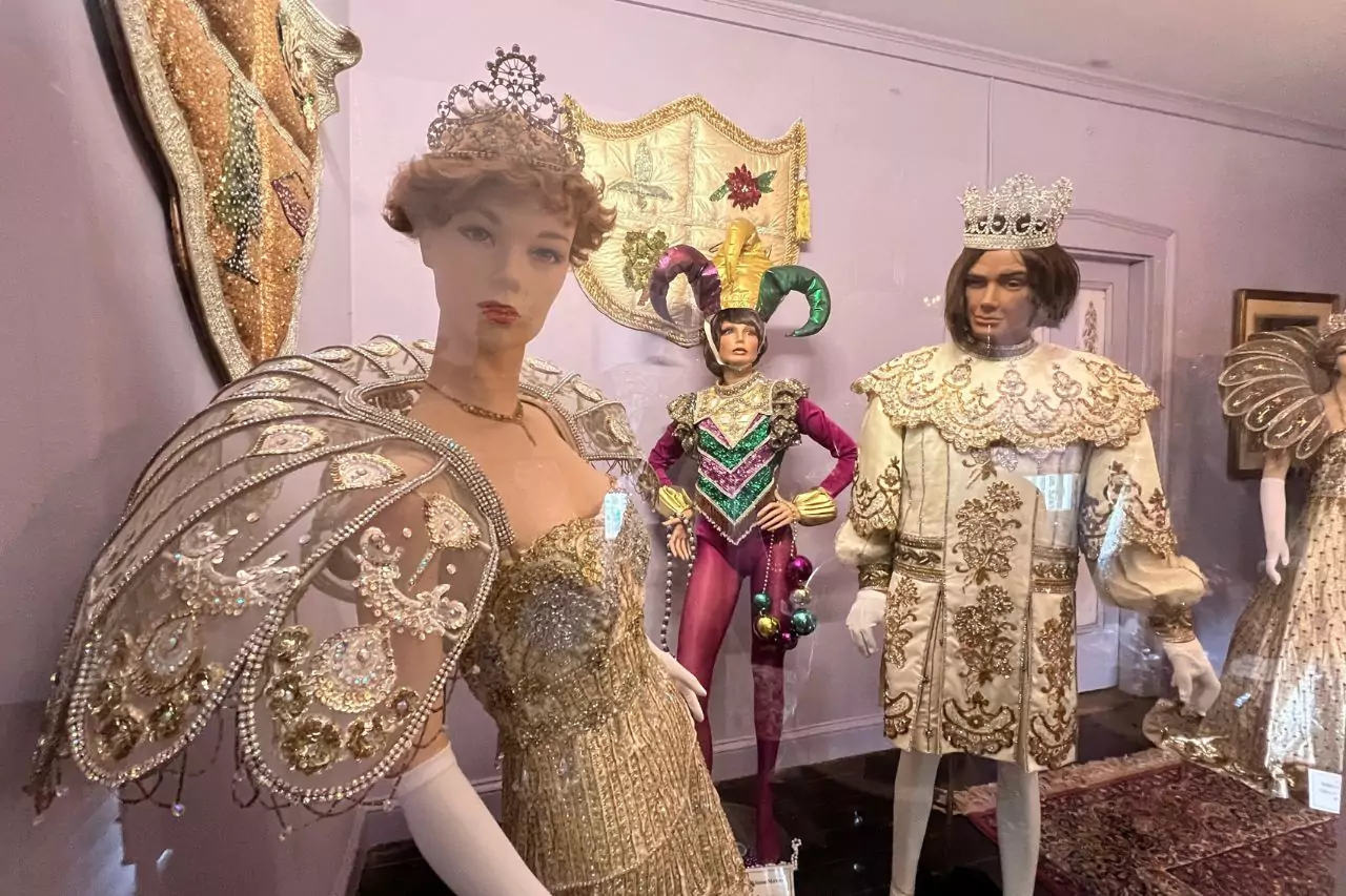 Mardi Gras Costume Display at Lafayette Museum Vibrant Mardi Gras costume exhibit at Lafayette Museum with mannequins dressed as royalty and jesters, featuring sequined gowns, capes, tiaras, and colorful masks.