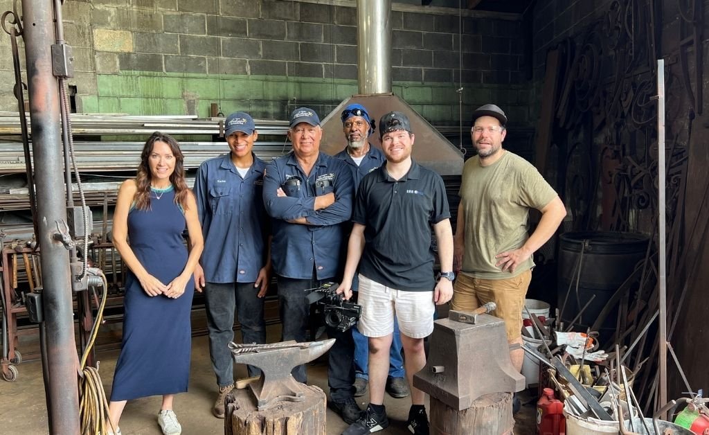 Karen LeBlanc with Darryl Reeves, apprentice Karina Roca, and collaborators inside the 7th Ward forge in New Orleans.
