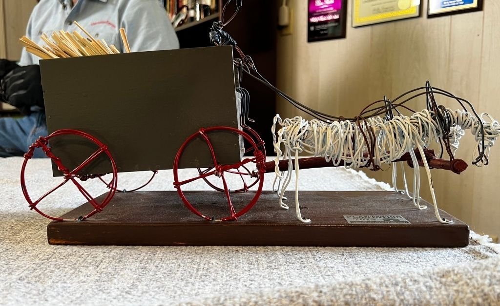 Wire and wood model of a mule-drawn wagon carrying kindling, handcrafted by Elvin Shields as part of his childhood-inspired folk art collection.