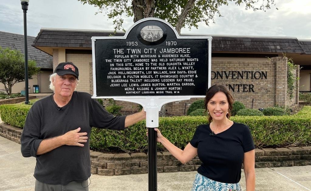 Enoch Doyle Jeter and Karen LeBlanc stand beside the Twin City Jamboree historical marker at the West Monroe Convention Center, honoring the local music show's legacy in Northeast Louisiana.