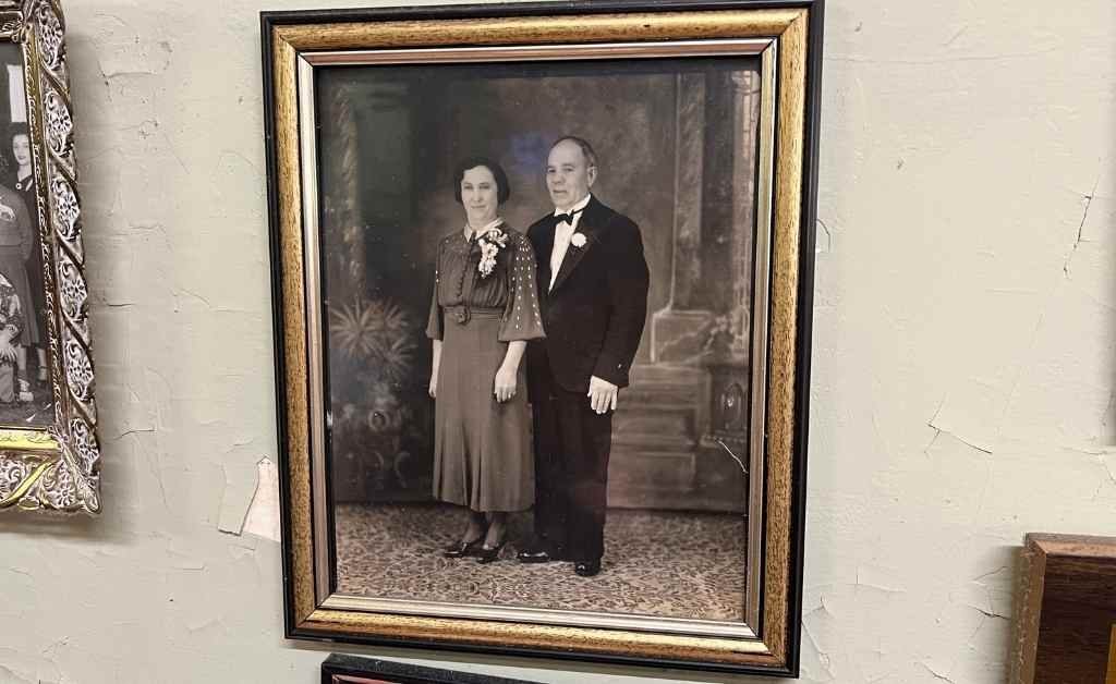 Framed vintage portrait of a man and woman from the Fertitta family, dressed formally and displayed on the wall inside Fertitta's Deli.