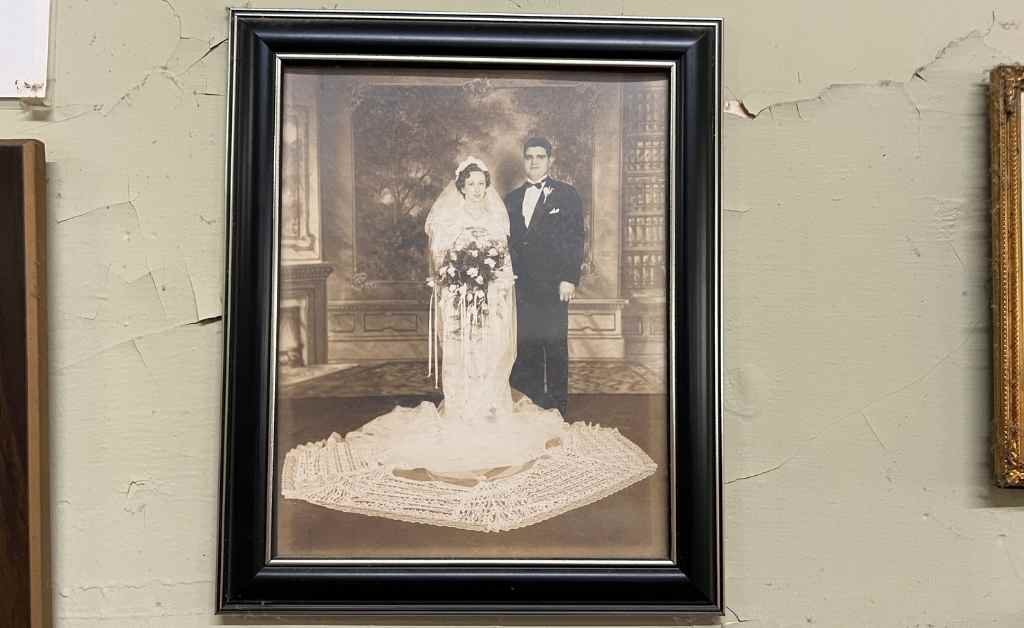 Framed vintage wedding portrait of a bride and groom, displayed on the wall inside Fertitta's Deli as part of the family's multi-generational history.