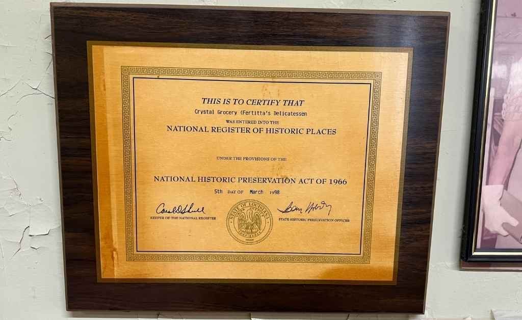 Framed certificate recognizing Crystal Grocery, later known as Fertitta's, as part of the National Register of Historic Places under the National Historic Preservation Act of 1966.