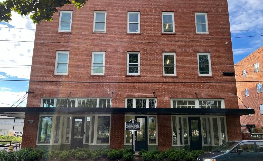 The historic Miller-Roy Building in downtown Monroe, Louisiana, with the Northeast Louisiana Music Trail marker in front. The building once housed the Savoy Ballroom, a significant venue on the Chitlin’ Circuit that supported African American musicians during segregation.