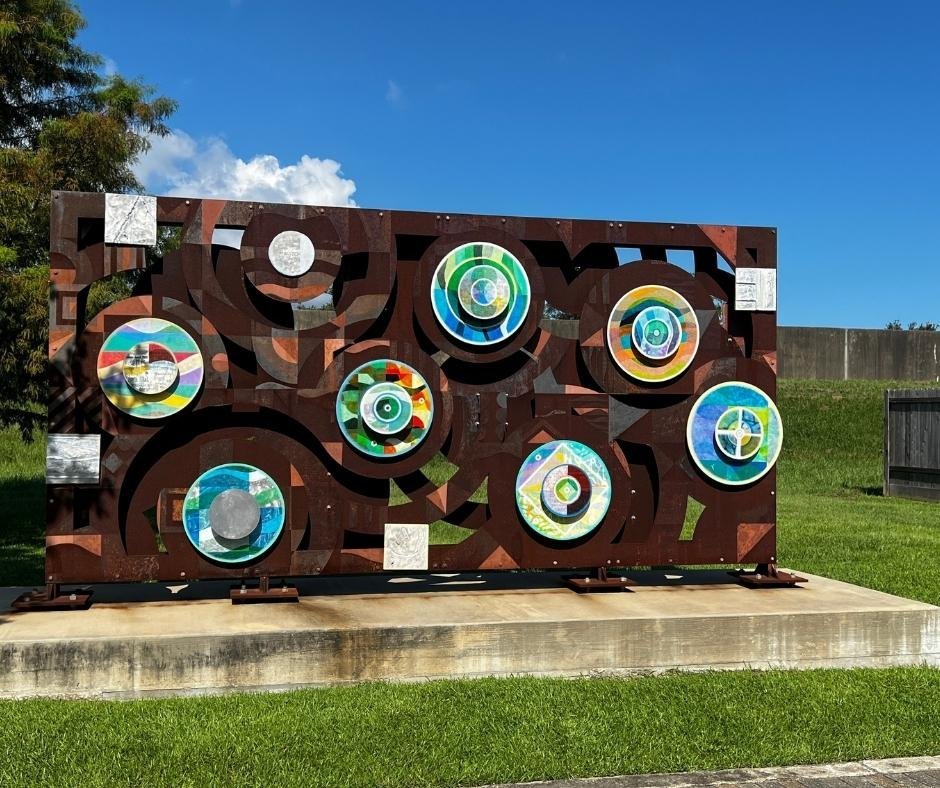 Colorful circular artwork installation at the Open Air Levee Exhibition and Garden in New Orleans, serving as a memorial to Hurricane Katrina’s floodwall breaches.