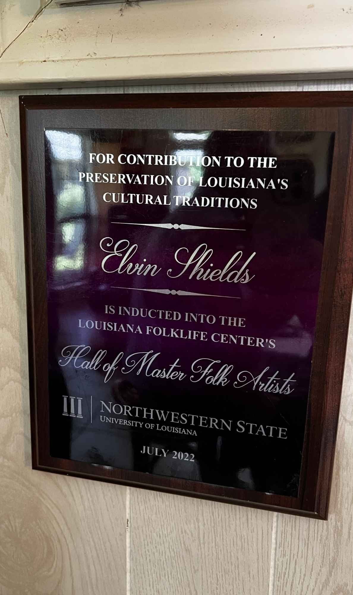Plaque awarded to Elvin Shields, recognizing his induction into the Louisiana Folklife Center’s Hall of Master Folk Artists at Northwestern State University in July 2022.