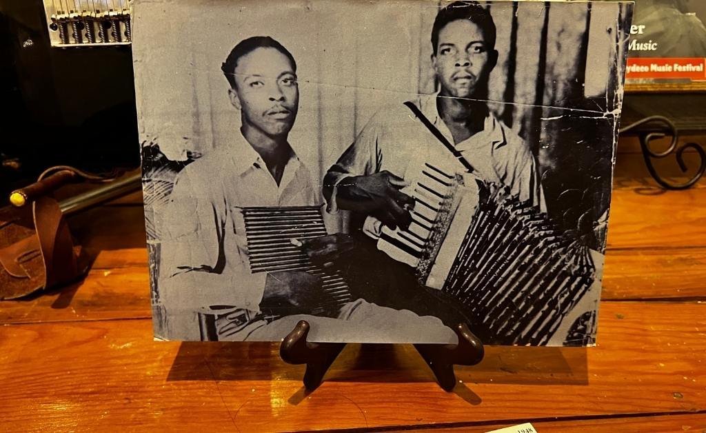 Historic black-and-white photo of Clifton Chenier playing accordion and his brother Cleveland Chenier playing the frottoir, central figures in Zydeco music.