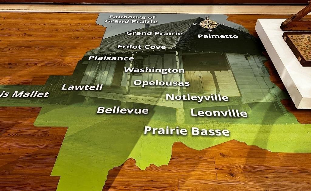 Floor map exhibit at the Opelousas Museum highlighting neighborhoods and communities of St. Landry Parish, including Opelousas, Plaisance, and Leonville.