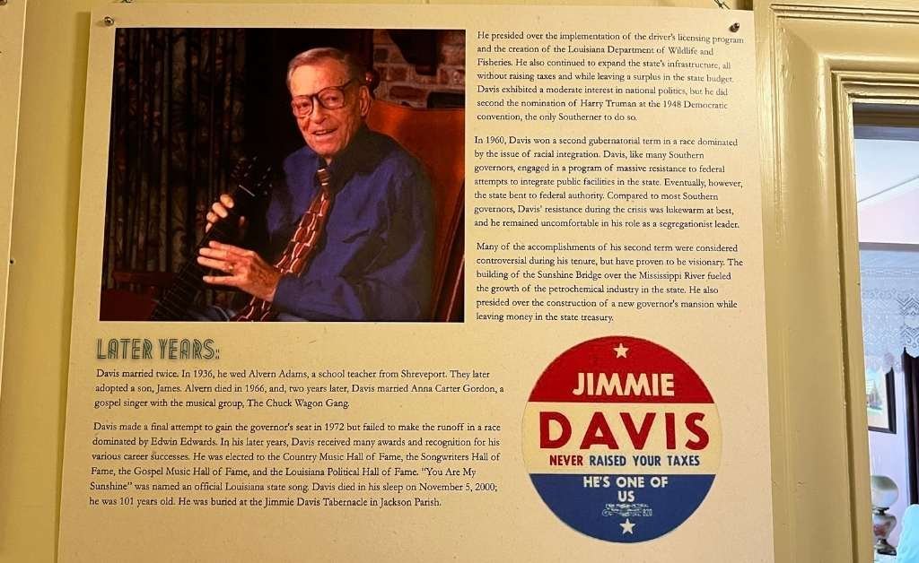 A display panel about Governor Jimmie Davis's later years, featuring a photograph of him holding a guitar, biographical text, and a campaign button reading “Jimmie Davis Never Raised Your Taxes – He’s One of Us.”