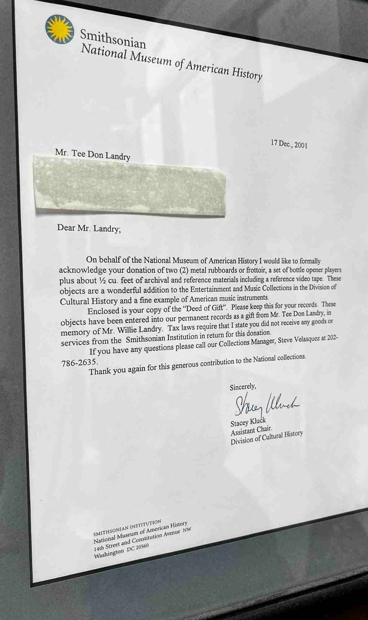 Framed letter from the Smithsonian National Museum of American History acknowledging Tee Don Landry’s donation of rubboards and archival materials in memory of his father, Willie Landry, dated December 17, 2001.