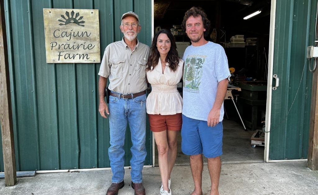 Karen LeBlanc standing with Larry Allain and Andre Allain outside the barn at Cajun Prairie Farm in Arnaudville, Louisiana.