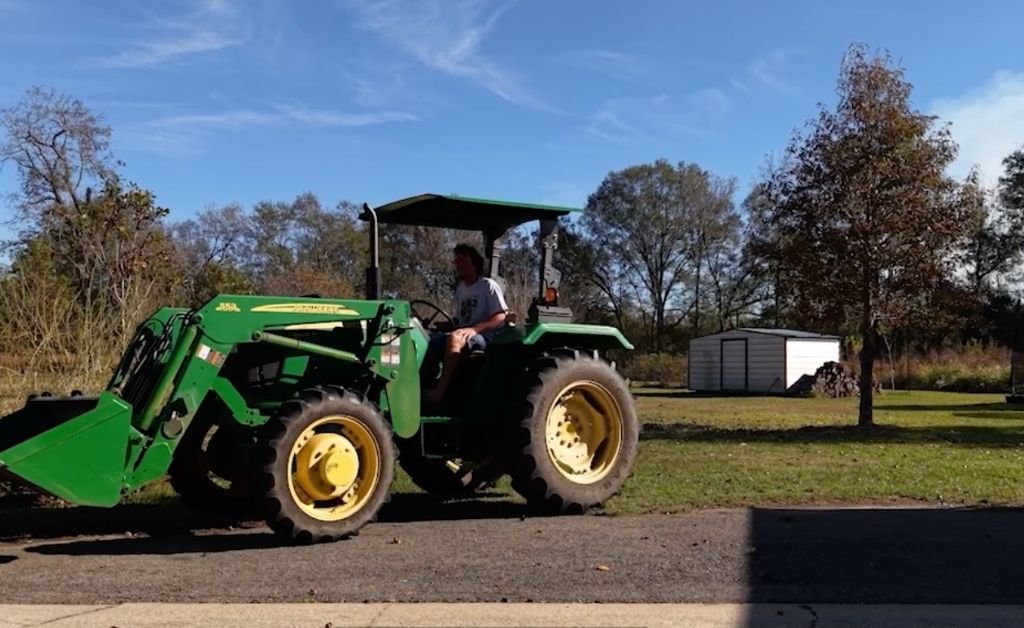 Andre Allain driving a tractor across the property at Cajun Prairie Farm in Arnaudville, Louisiana.