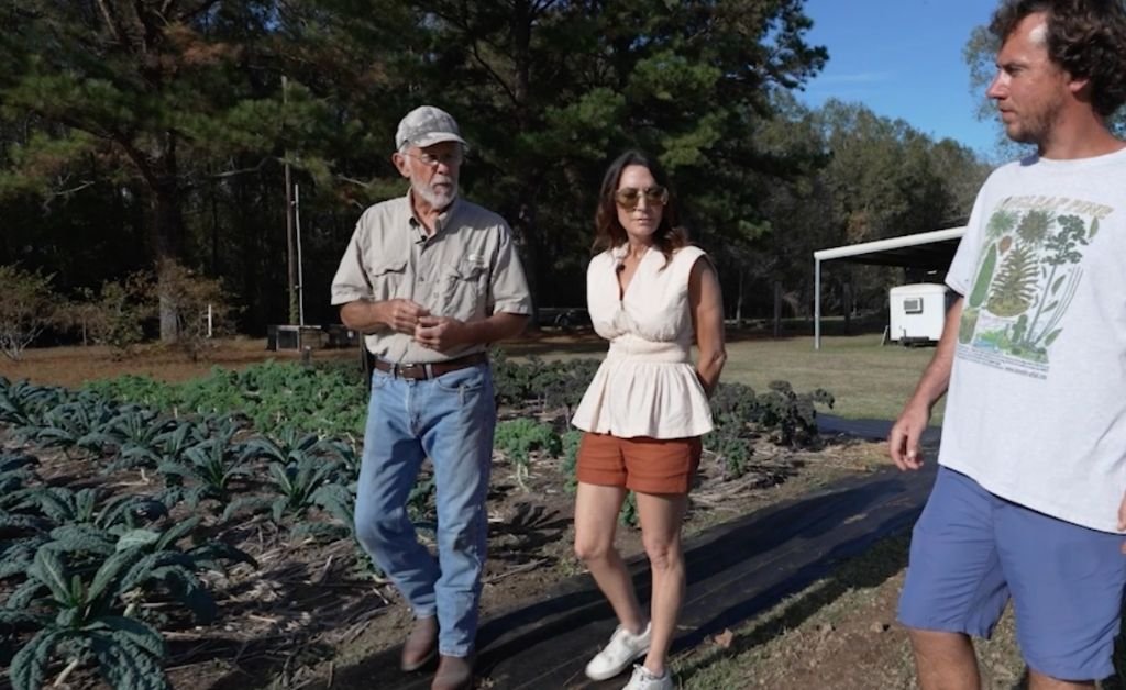 Larry Allain walking through the garden beds with Karen LeBlanc and Andre Allain at Cajun Prairie Farm in Arnaudville, Louisiana.