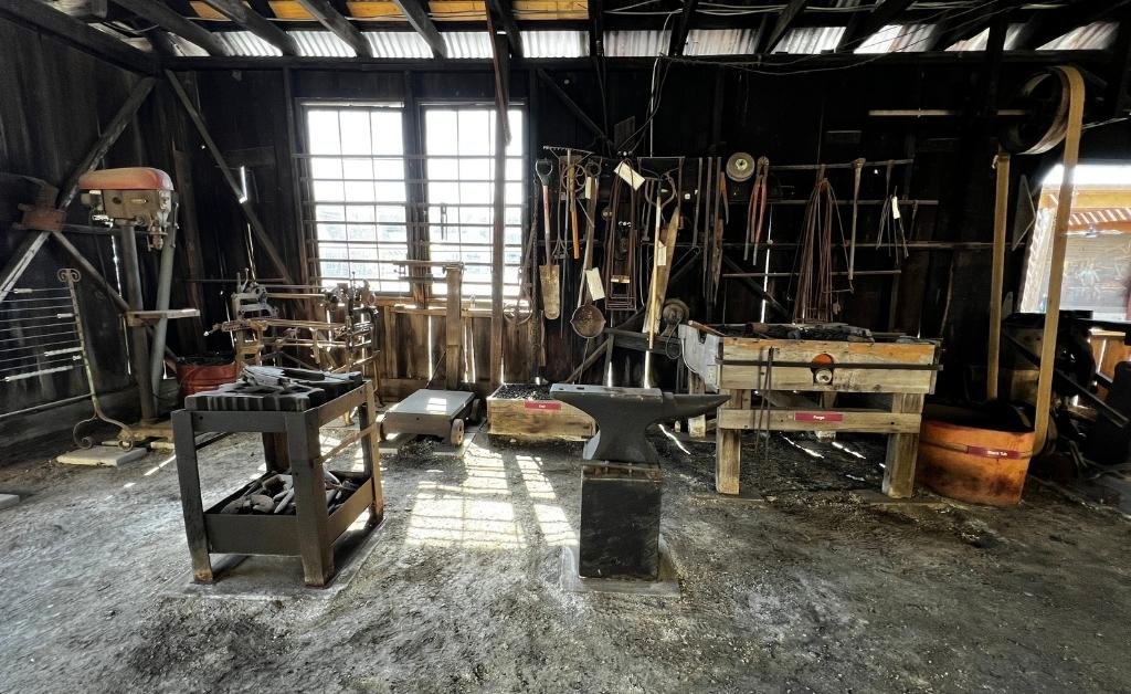 Original anvils, forge, and hand tools inside the Sam Guarino Blacksmith Shop Museum in Abbeville, Louisiana.