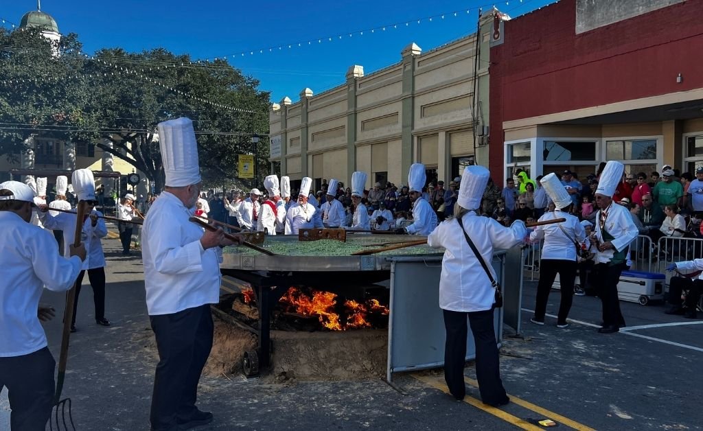 Chevaliers cook the giant omelette over an open flame during the Giant Omelette Celebration in downtown Abbeville, Louisiana