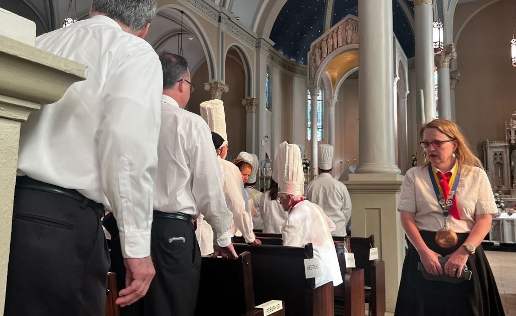 Members of the Omelette Confrérie attend Mass at St. Mary Magdalene Church during the Giant Omelette Celebration in Abbeville