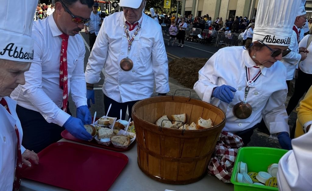 Chevaliers prepare bread and omelette servings during the Giant Omelette Celebration in Abbeville, Louisiana