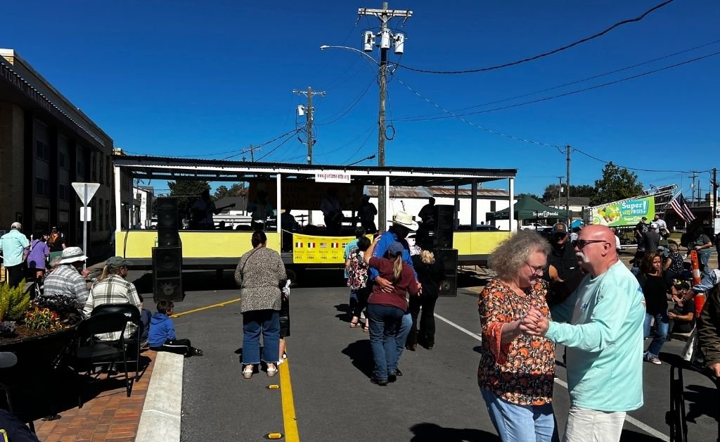 Visitors dance to live music during the Giant Omelette Celebration in downtown Abbeville, Louisiana