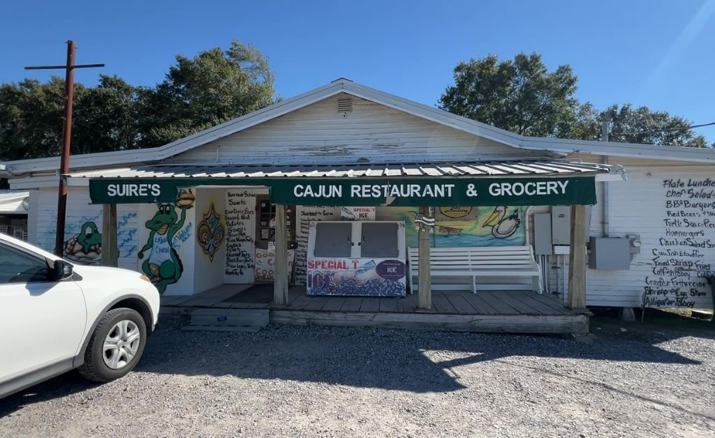 Exterior of Suire's Grocery and Restaurant in Kaplan, Louisiana, with the spray-painted menu on the facade