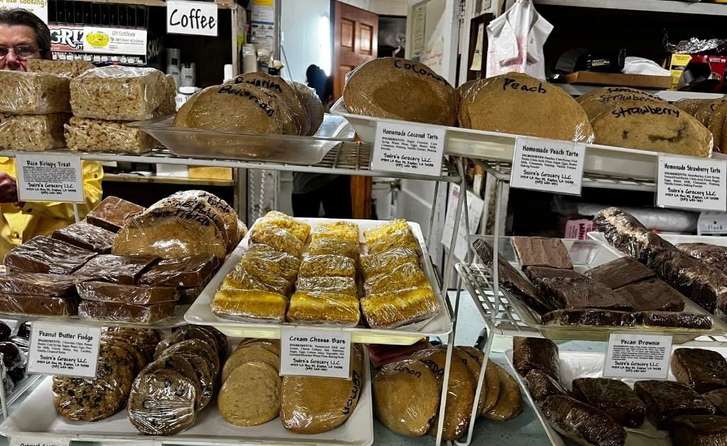 'Display case of homemade baked goods including tarts, brownies, and cream cheese bars at Suire's Grocery and Restaurant