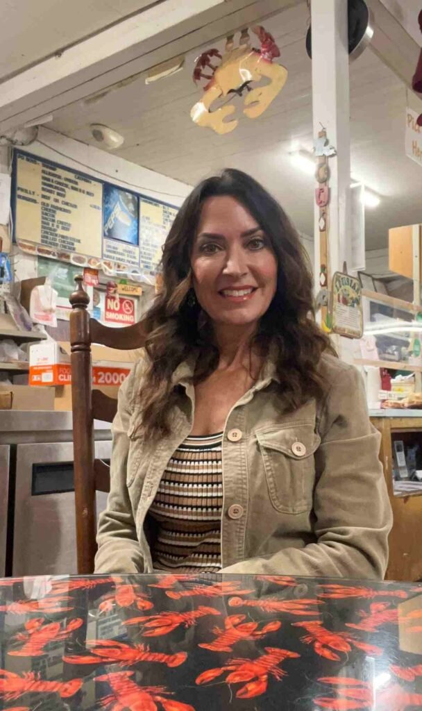 Karen LeBlanc seated at a table inside Suire's Grocery and Restaurant in Kaplan, Louisiana