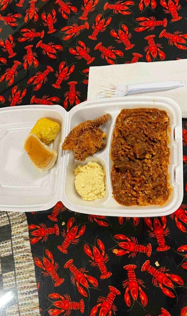 Turtle sauce picante plate with rice, fried chicken, cornbread, and potato salad at Suire's Grocery and Restaurant
