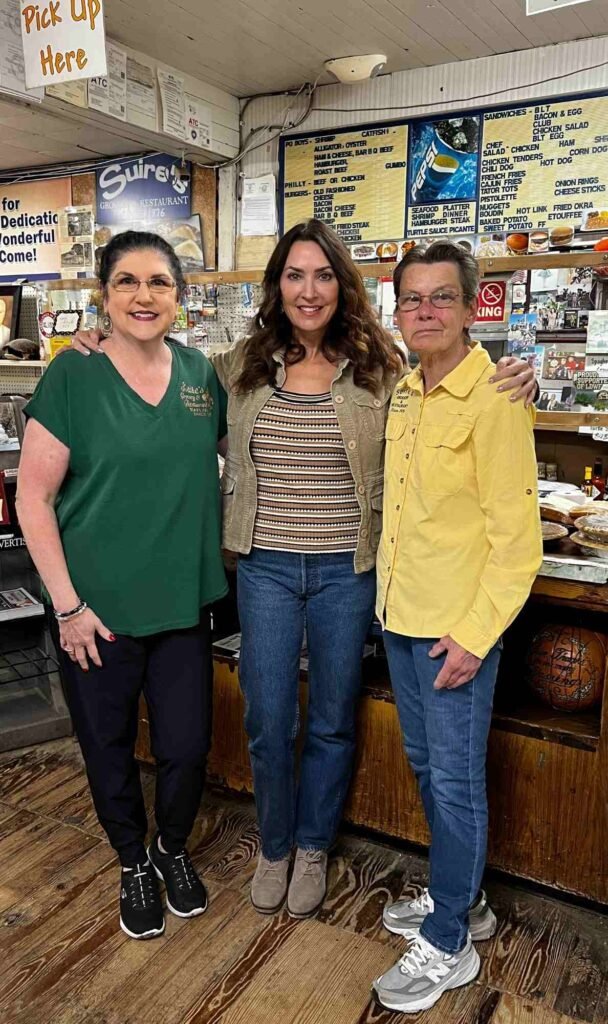 Karen LeBlanc standing with Joan Suire and Lisa Suire Frederick inside Suire's Grocery and Restaurant in Kaplan, Louisiana