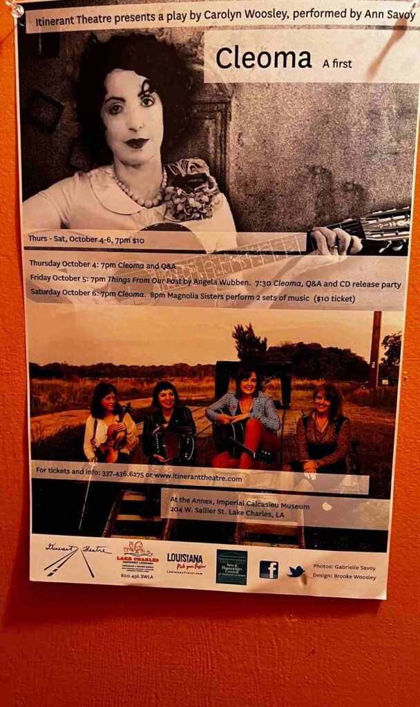 A promotional poster for the play “Cleoma” by Carolyn Woosley, performed by Ann Savoy, presented by Itinerant Theatre. The poster shows a black‑and‑white portrait of a woman holding a guitar at the top and a photo of four women with guitars in an outdoor setting below, with event details listing performances on October 4‑6 at the Annex, Imperial Calcasieu Museum in Lake Charles, LA.