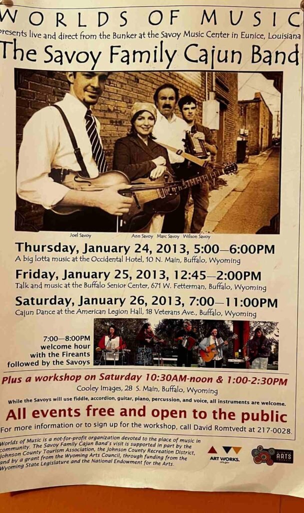 A promotional poster for “Worlds of Music” featuring the Savoy Family Cajun Band. It shows a sepia photo of four band members and lists three free public events in Buffalo, Wyoming, on January 24–26, 2013, including performances and a workshop.