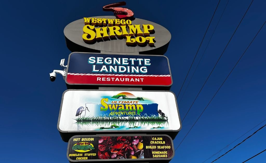 Sign for Westwego Shrimp Lot in Westwego, Louisiana, featuring Segnette Landing Restaurant and Ultimate Swamp Adventures, highlighting the longtime family-owned seafood market operated by the Temento family for three generations.
